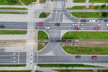 A road in the city with a top view, trams and cars are passing along the road, Poland, Wroclaw