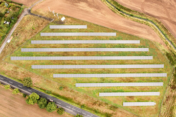 Solar farm on the field, many solar panels in a row. Alternative power source