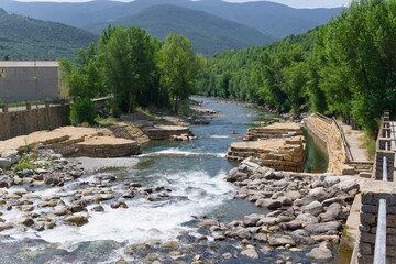 View from a bridge of the waterfall in the Noguera Pallaresa river as it passes through the town of Sort in Lleida