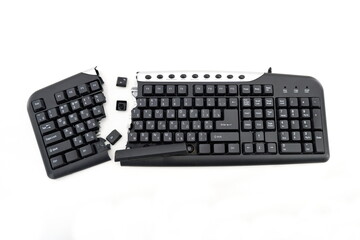 Broken keyboard. Destroyed keyboard. Black PC Keyboard is smashed and broken in half. PC repair...
