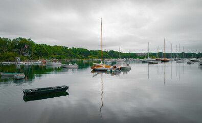 Fototapeta na wymiar Tranquil seascape with moored boats and yachts at the cloudy marina