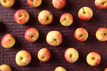 Fresh red apple fruit on red background, Flat lay