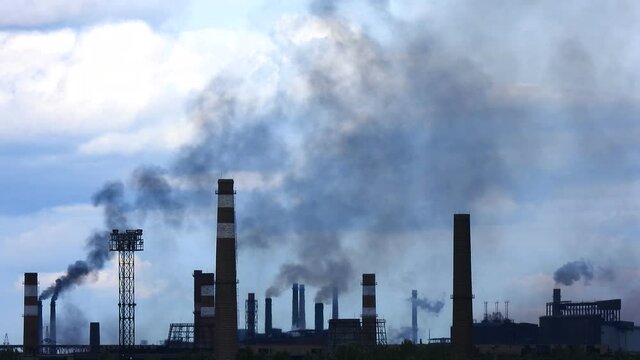 Smoking chimneys industrial landscape time lapse. Air pollution background. Smoke industry pattern. Heavy industry blue sky. Epic pollution of nature. Toxic substances.