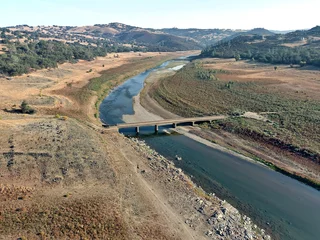 Foto auf Acrylglas Photos of the Hidden Bridge at Folsom Lake. Usually submerged under 60 feet of water this bridge is visible due to the severe drought in California.  © Chris