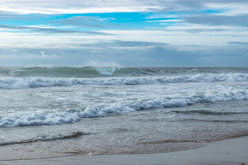 Fototapeta na wymiar Atlantic Ocean with three powerful waves breaking on Esposende beach PORTUGAL