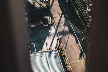 office workers walk on the morning street near Osaka Namba. A street photo shot from high up to...
