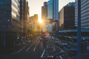 Osaka downtown area in the early morning with bright sunlight and tall skyscrapers. The early morning city landscape 