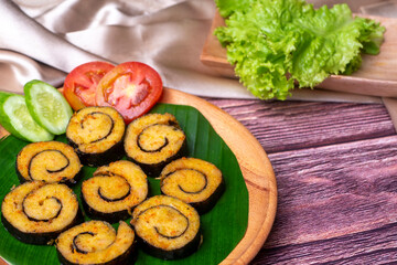Nori Chicken Nugget, healthy food from vegetables on white plate and wooden table decorated with lettuce, tomato, and cucumber