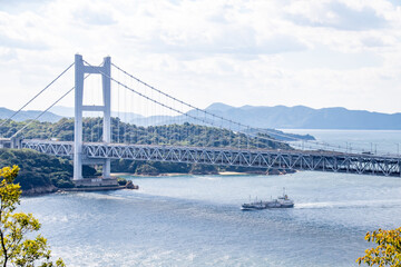 瀬戸大橋と船の風景　岡山県倉敷市　The view of Seto Ohashi bridge at Setonaikai, Inland Sea of Japan, and a freight vessel in Kurashiki city, Okayama pref. Japan