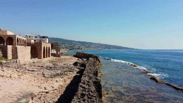 Waterfront Buildings Near Phoenician Wall, Ancient Sea Wall In Batroun, Lebanon. - aerial