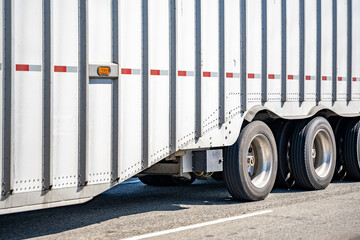 Naklejka premium Heavy-duty bulk semi trailer with stiffening rib and three axes running on the wide highway