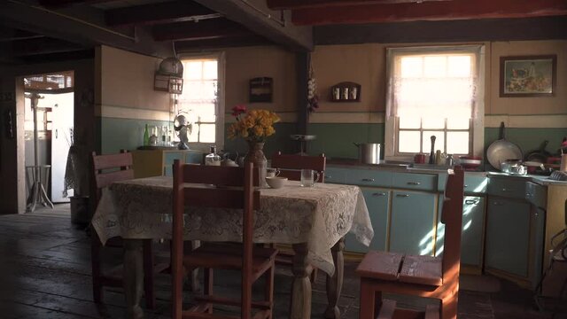 Old dining table in a decorated antique kitchen full of sunlight,zoom.