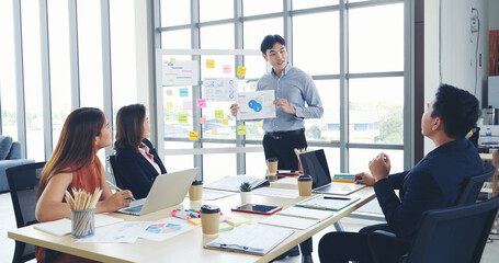 Happy business people meeting present graph chart investment, business data in meeting room. Group...