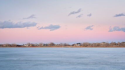 frozen lake after sunset with houses at waterfront - Boyd Lake in northern Colorado