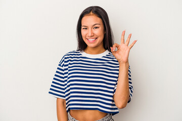Young latin woman isolated on white background  cheerful and confident showing ok gesture.