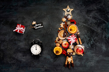 Christmas tree made of food on dark background.