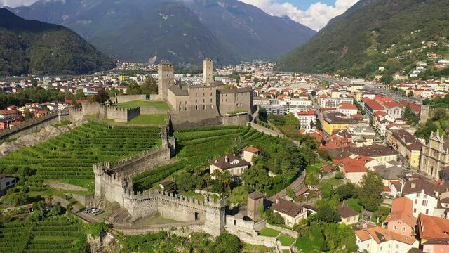 Aerial drone footage of Bellinzona old town and the Castelgrande medieval castle in Canton Ticino in Switzerland. Shot with a tilt down motion. 