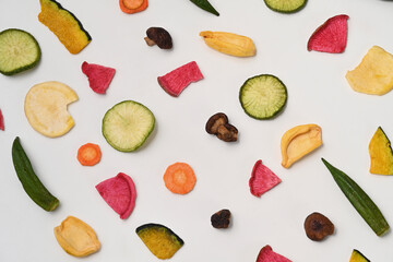 Dried mixed vegetable chips on white background.