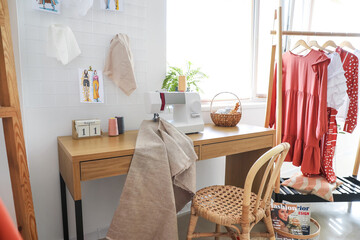 Tailor's workplace with sewing machine and cloth in atelier