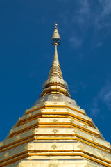 Fototapeta premium Low angle view of golden pagoda against clear blue sky