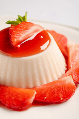 Plate with delicious strawberry panna cotta, closeup