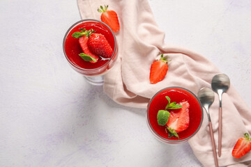 Glasses with tasty strawberry panna cotta and mint on white background