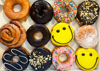 12 assorted colored donuts in a box, top view