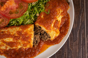 Minced meat pancake with dressing and salad