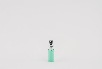 transparent bottle with blue liquid spray tip