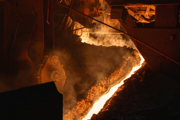 The process of tapping molten metal and slag from a blast furnace.