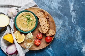 Bowl with tasty baba ghanoush and ingredients on color background