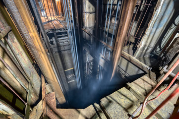 Mine elevator shaft. A lot of ropes are lowered into the shaft - Powered by Adobe