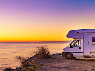 Rv camper camping on sea shore, Spain.