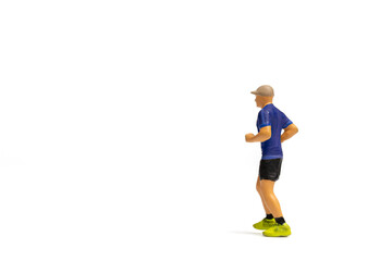 Miniature people, Man in fitness wear running on white background and space for text