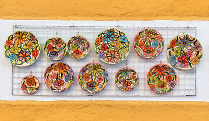 Beautiful ceramic dishes on the wall in the Spanish city of Marbella