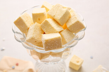 Bowl with tasty sweet marshmallows on light background