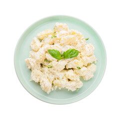 Plate of delicious gnocchi with creamy sauce on white background