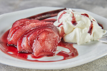 White chocolate mousse with pears in red wine on serving plate