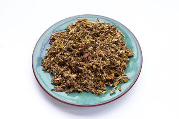 Dried absinthe wormwood in plate on white background.