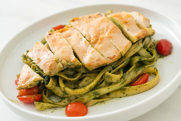 fettuccine spaghetti pasta in pesto sauce with grilled chicken