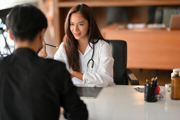 An Asian female doctor gives a patient advice and medication instructions