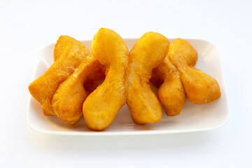 Deep-fried dough sticks or chinese bread sticks on white background.