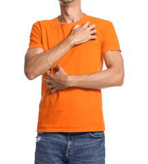 Young man scratching himself on white background