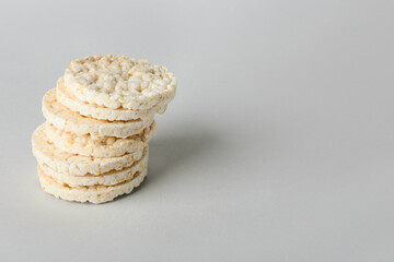 Stack of crispy rice crackers on grey background