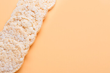 Crunchy rice crackers on color background