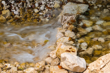 A Creek Beautifully Flowing through a Small Stone Dam