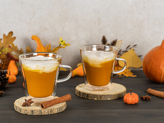Pumpkin spice latte in glass mugs with cinnamon, nutmeg, and whipped cream. seasonal, autumn drink
