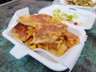 Roti, a traditional Indian dish from street food shop in Thailand, is packed in a foam box.