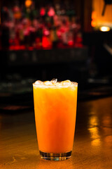 orange cocktail with ice on a dark background