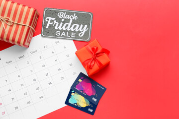 Calendar page of November 2022, credit cards and gifts on color background. Black Friday
